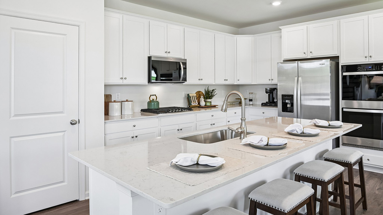 White kitchen built to enthrall guests and provide generous counterspace.