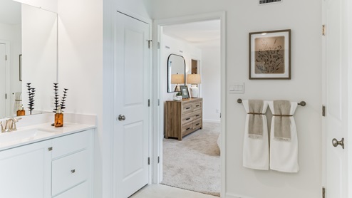 Primary bathroom with linen closet and separate room for the toilet.