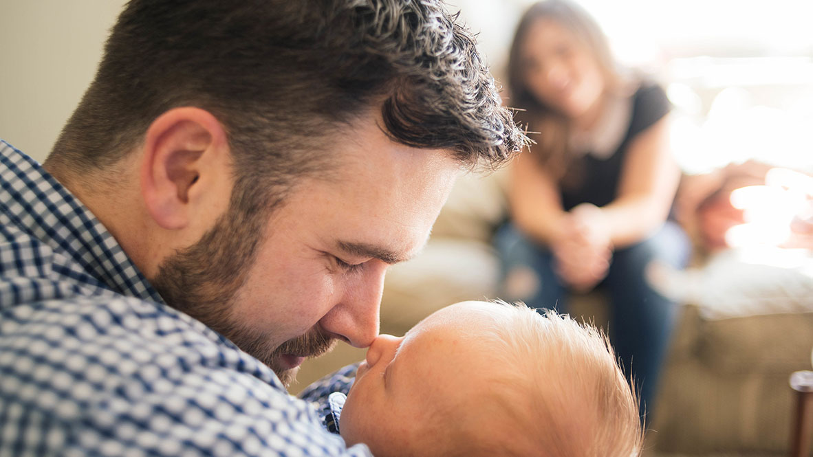 dad kissing baby's nose