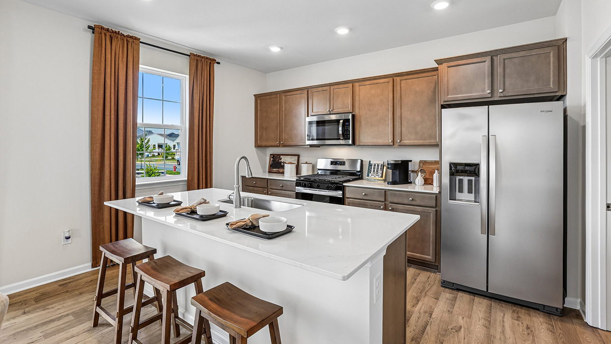 The kitchen island features a single sink.