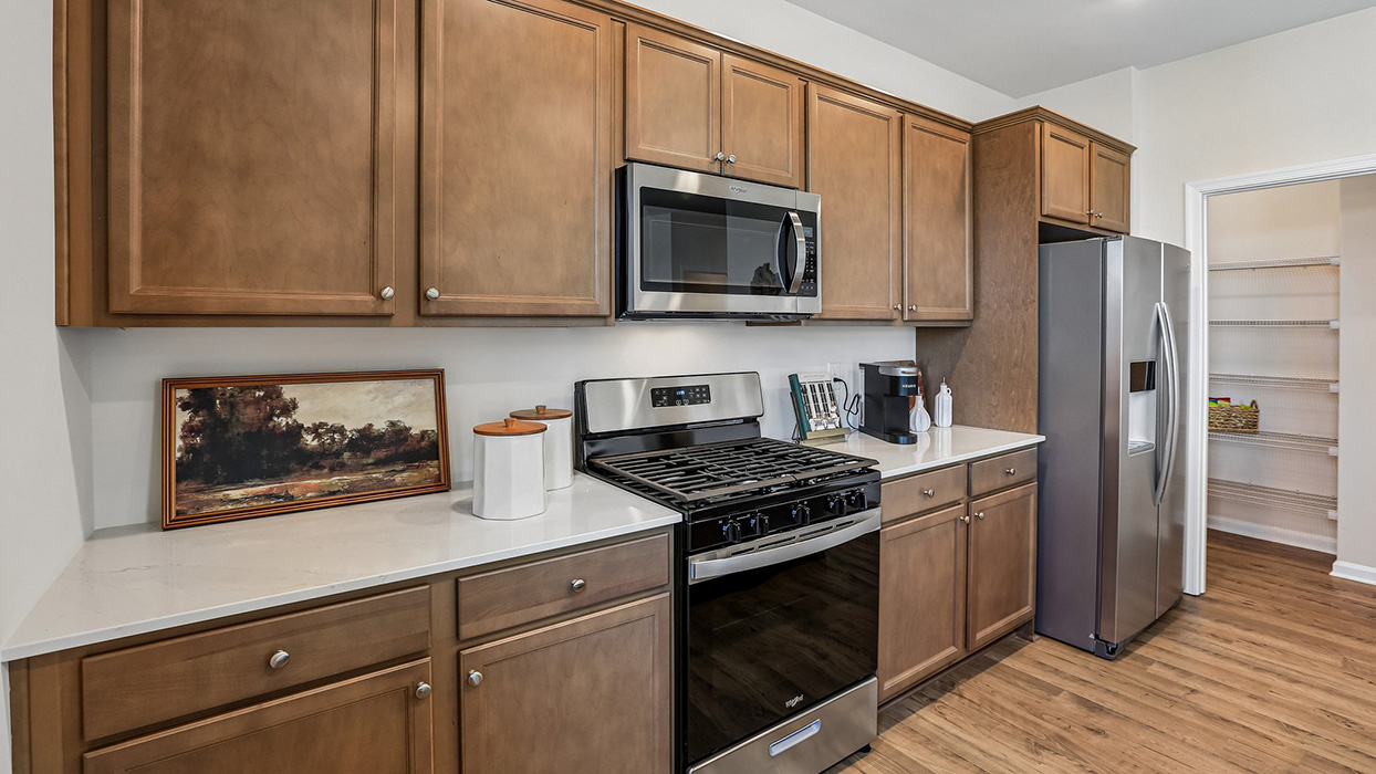 The well-designed gourmet kitchen features expansive cabinet storage.