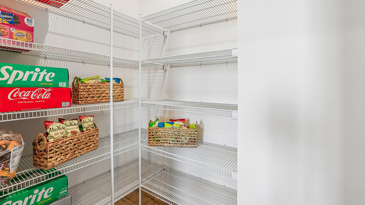 The well-designed gourmet kitchen features an oversized corner pantry.
