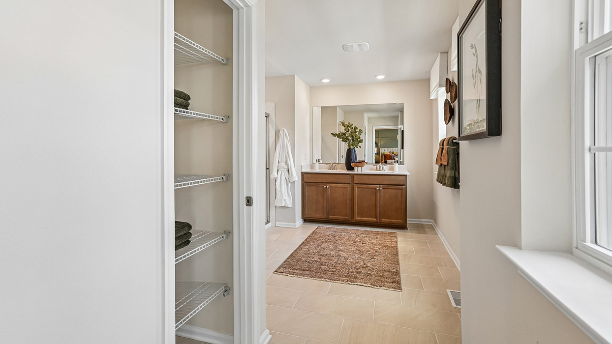 A view from the hallway of the contemporary owner’s bathroom.