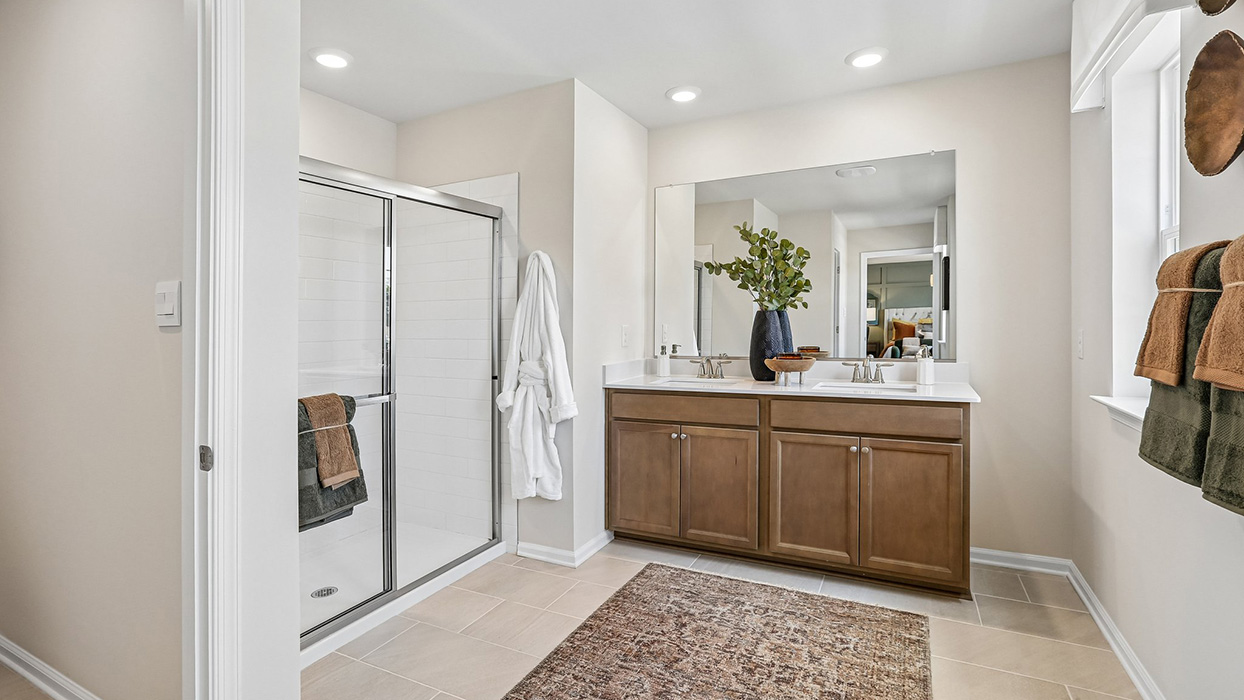 The owner's suite bathroom with double vanity and large shower.