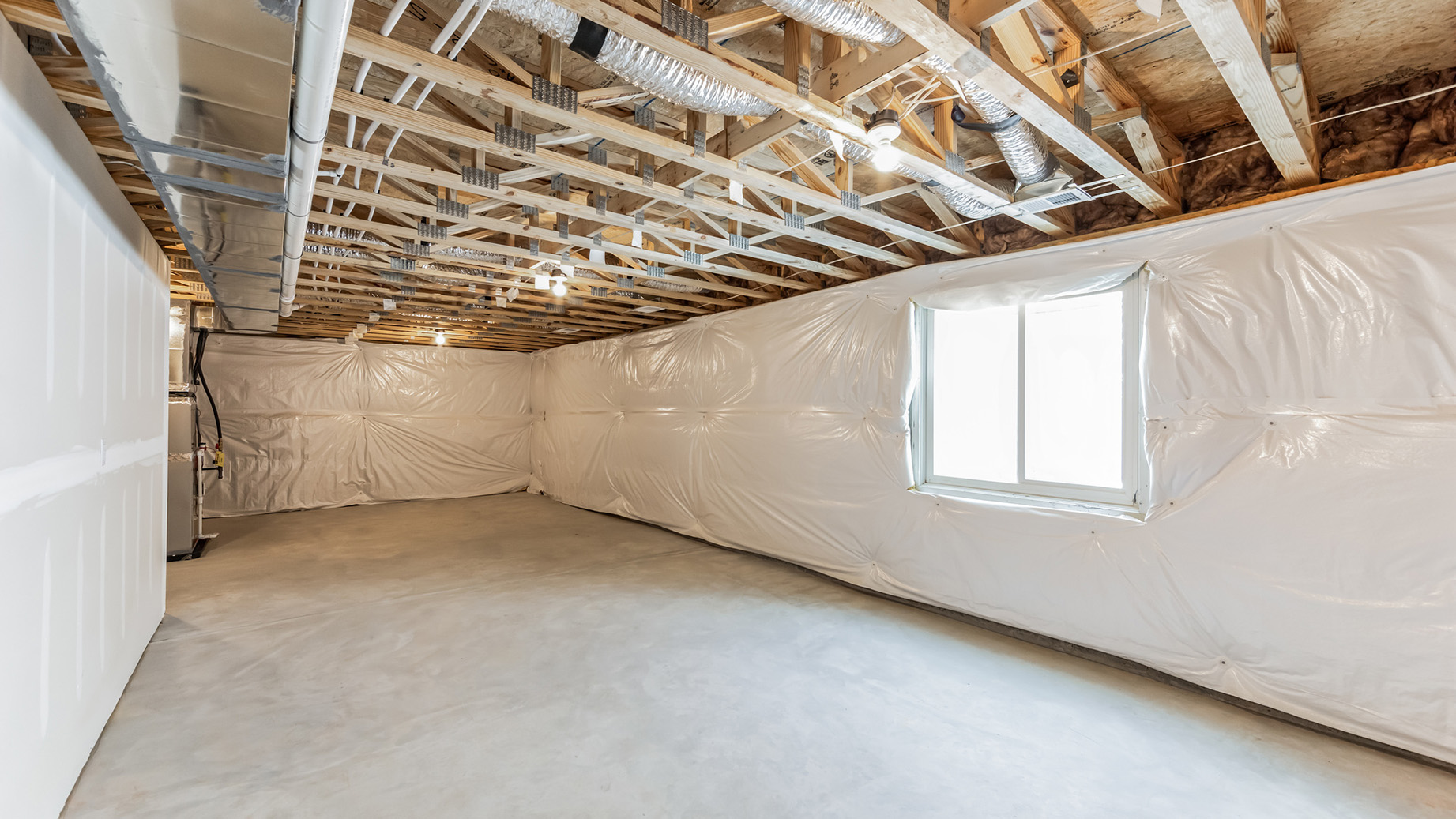 The unfinished basement space with sliding rear window.