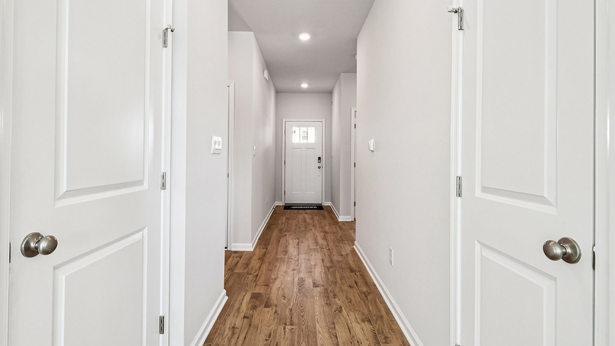 Entryway foyer with hallway to the bathroom on the left.