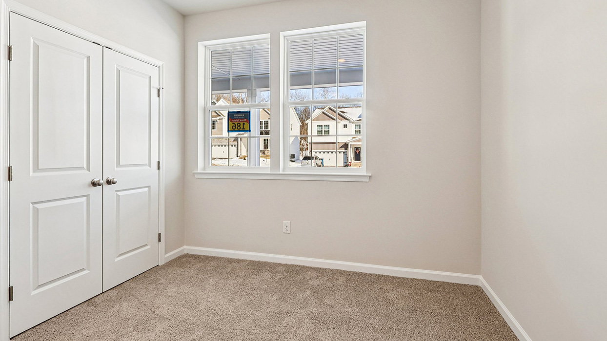 Bedroom two with two windows and double door closet