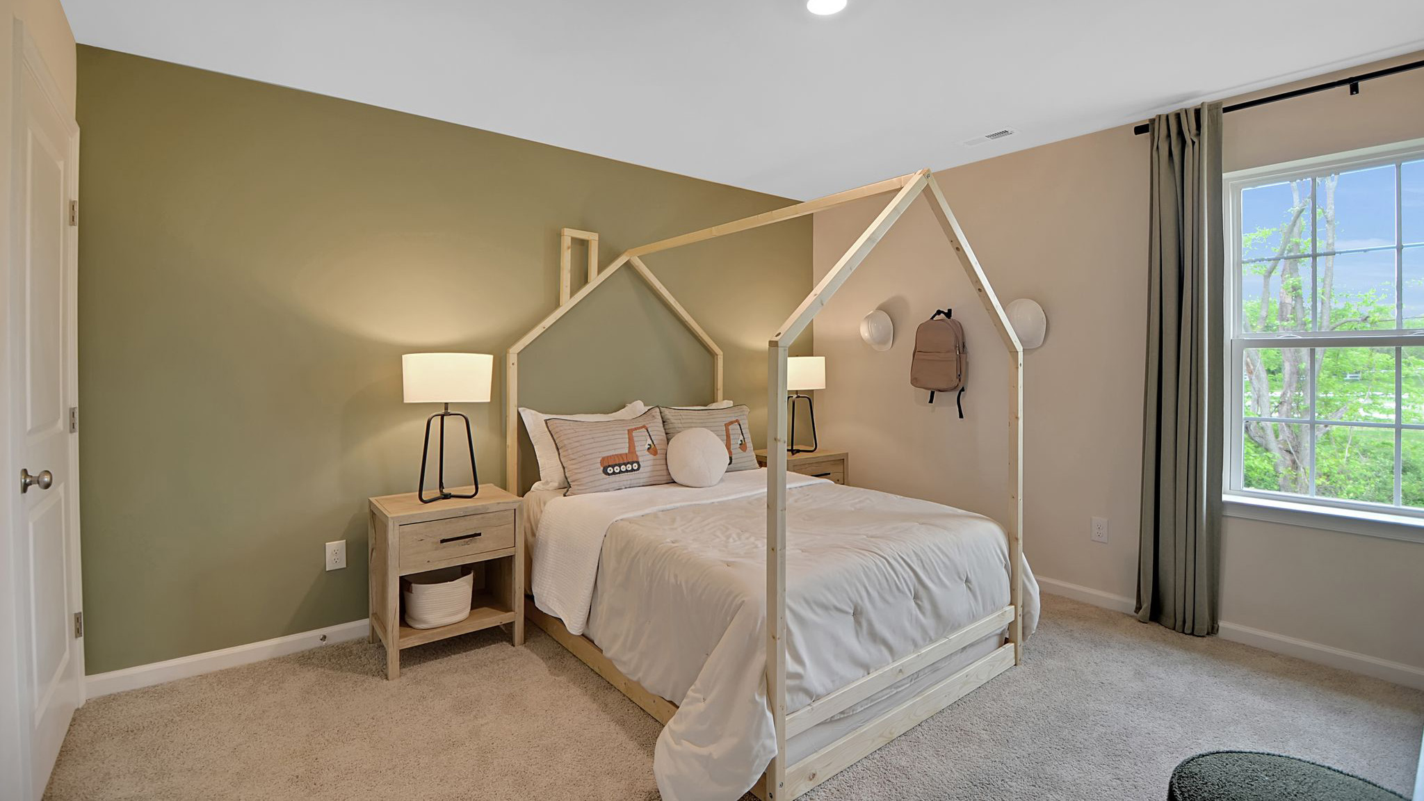 Bedroom with an olive green accent wall. Single window to the right and closet across from the window.