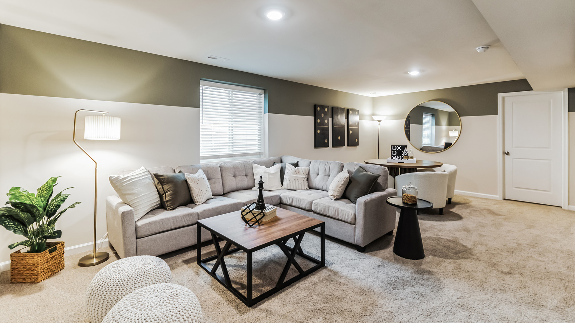 Wide frame view of the basement living room an dining area.