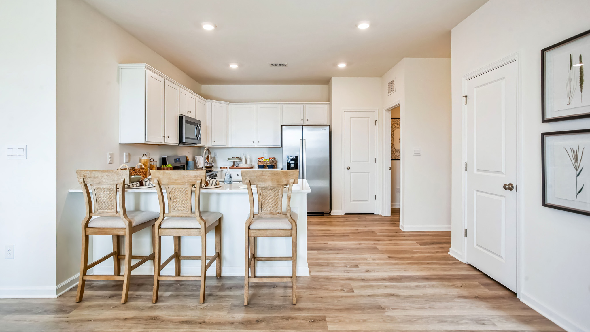 Facing the kitchen with view of the pantry closet and laundry closet to the right.h