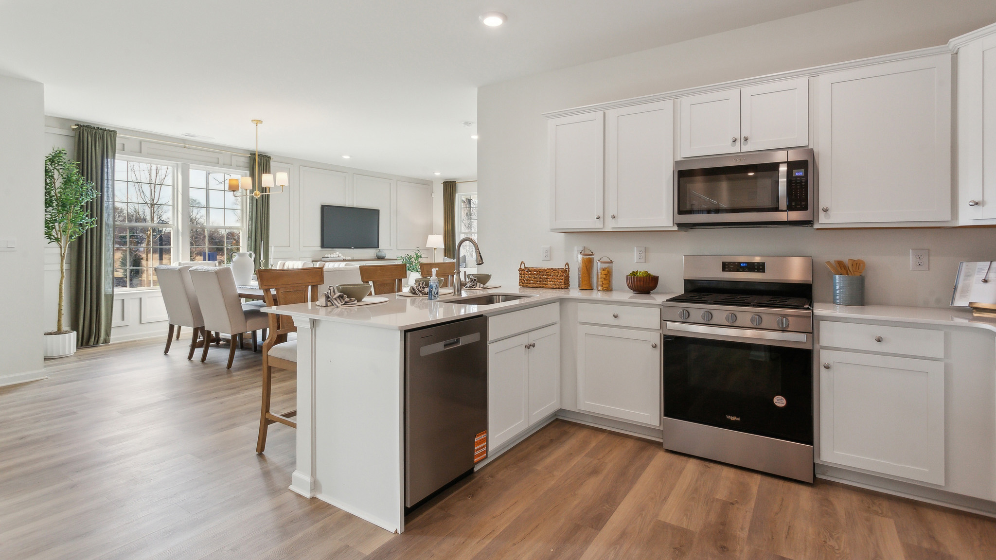 The open-concept kitchen features stainless steel appliances.