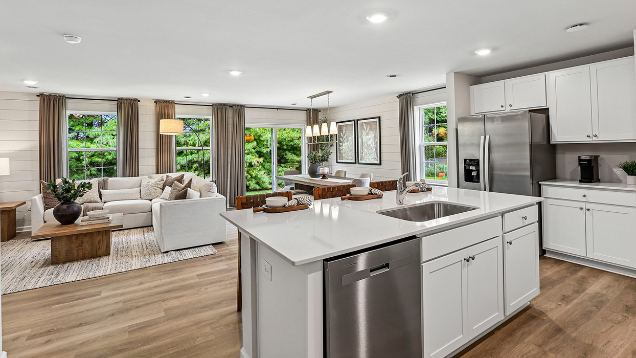 Kitchen with oversized island and stainless steel appliances in an open-concept design