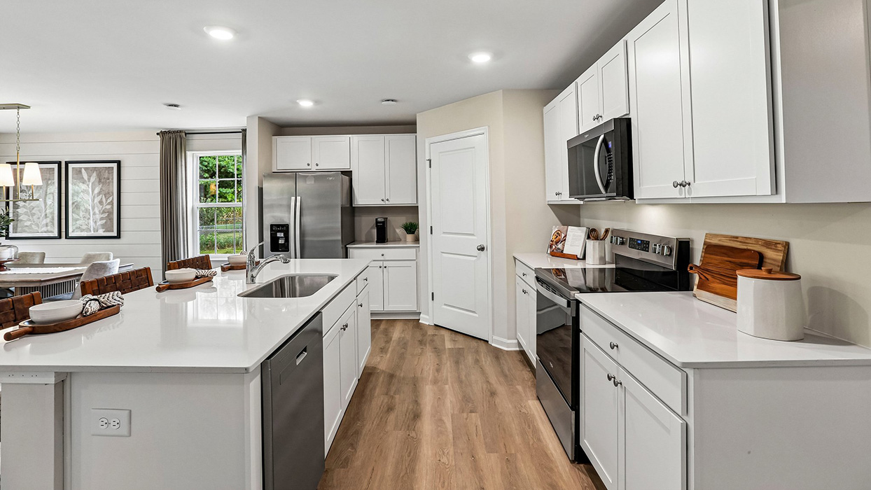 Kitchen with white cabinets and open-concept design connecting to main living spaces