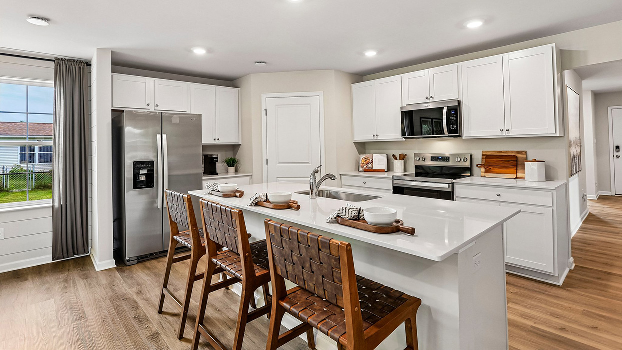 Kitchen with stainless steel appliances, ample counter space, and adjacent walk-in pantry