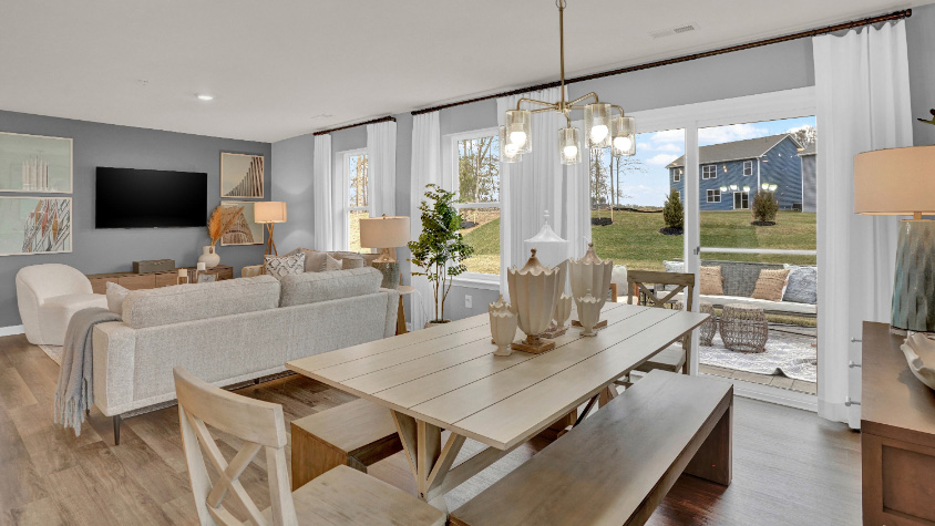 Open-concept dining and living area with expansive windows and seamless layout ideal for entertaining