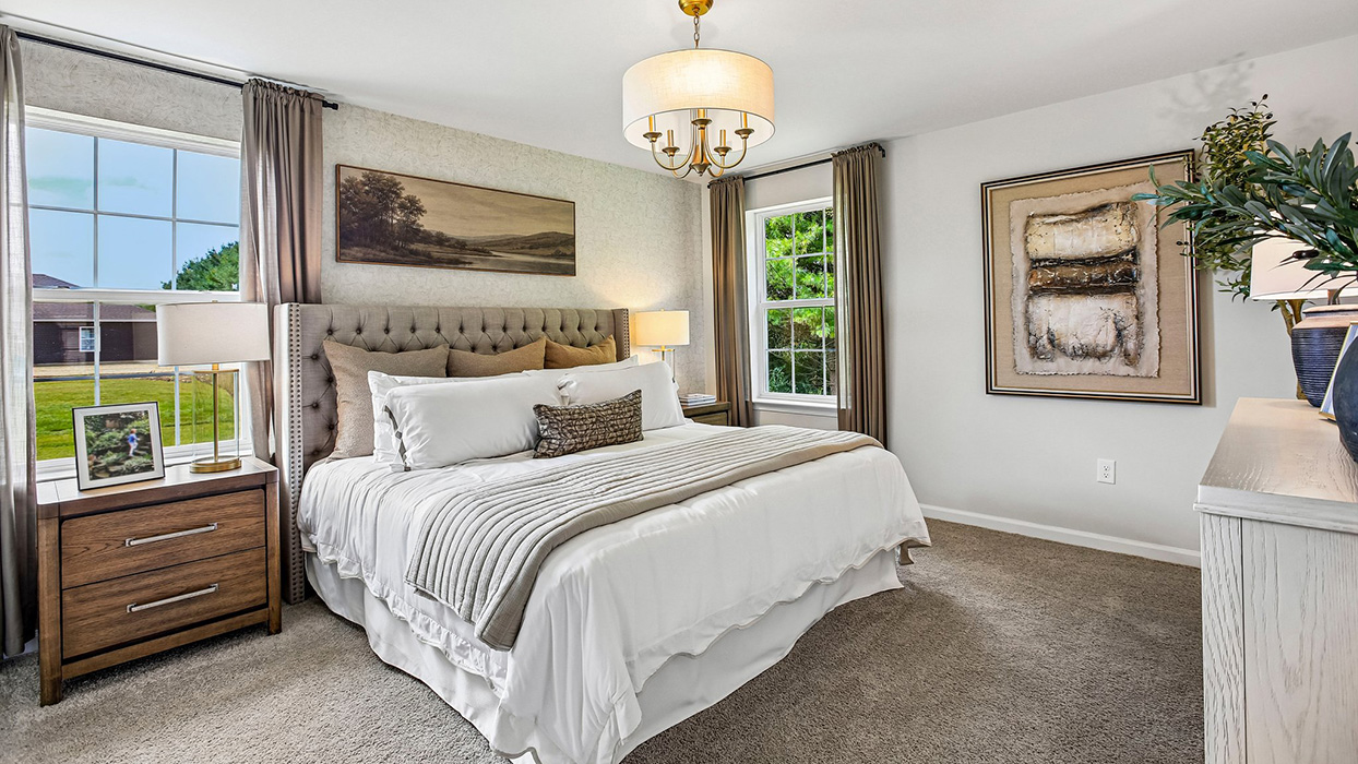 Primary bedroom with large windows, and spacious layout for added comfort