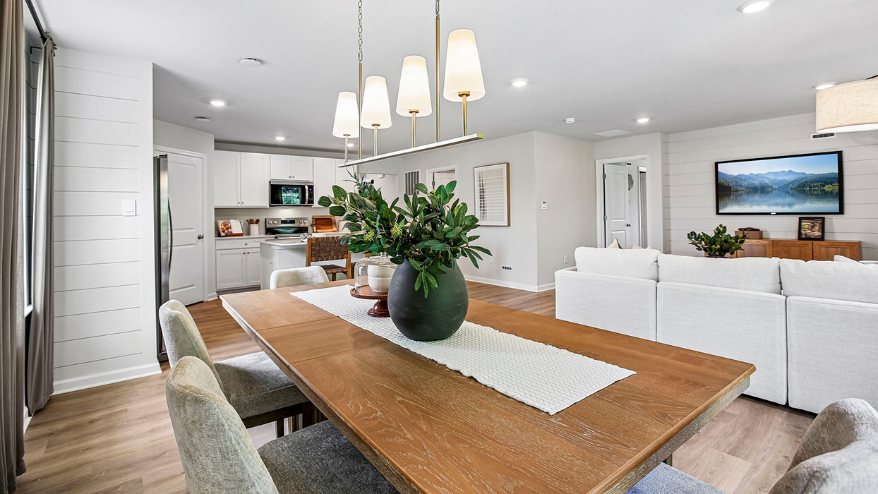 Open-concept dining with pendant lighting and living area with a seamless layout ideal for entertaining