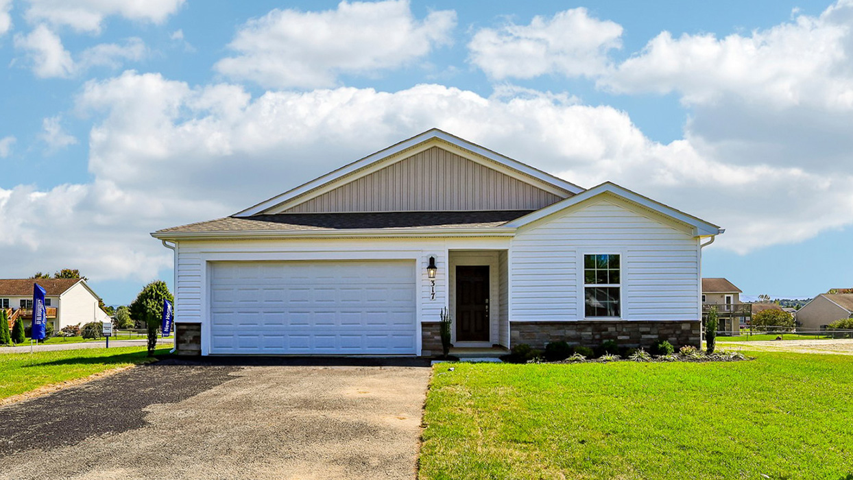 A Neuville exterior photo with white siding, champagne ledgestone kneewall, and a white garage door.