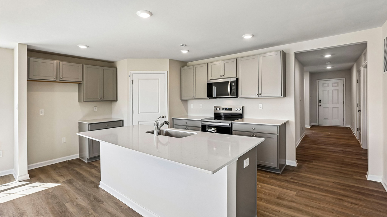 kitchen with gray cabinets and stainless steel appliances and corner pantry