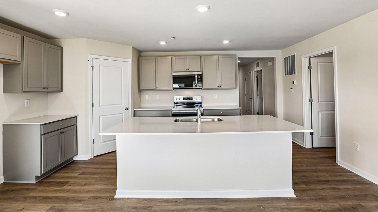kitchen large island with gray cabinets and stainless steel appliances
