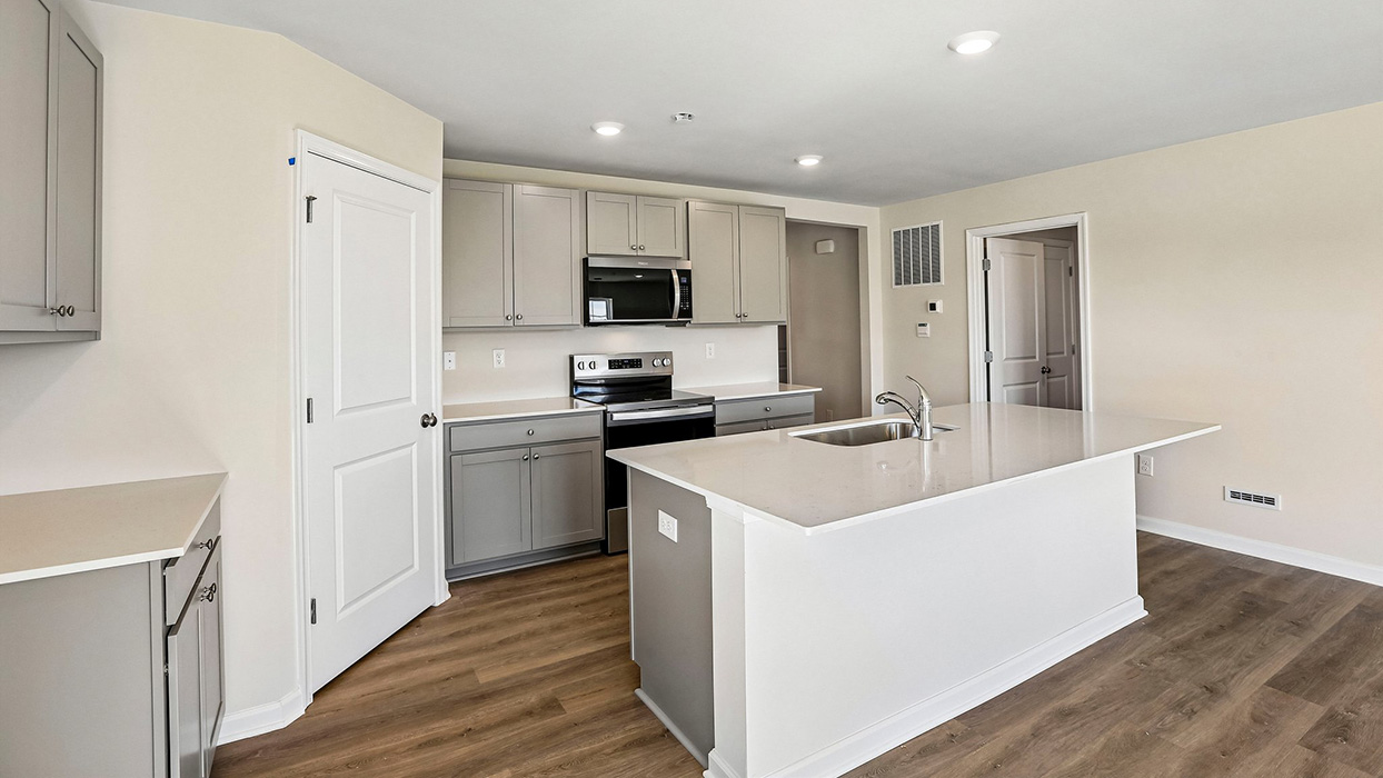 kitchen with gray cabinets and stainless steel appliances