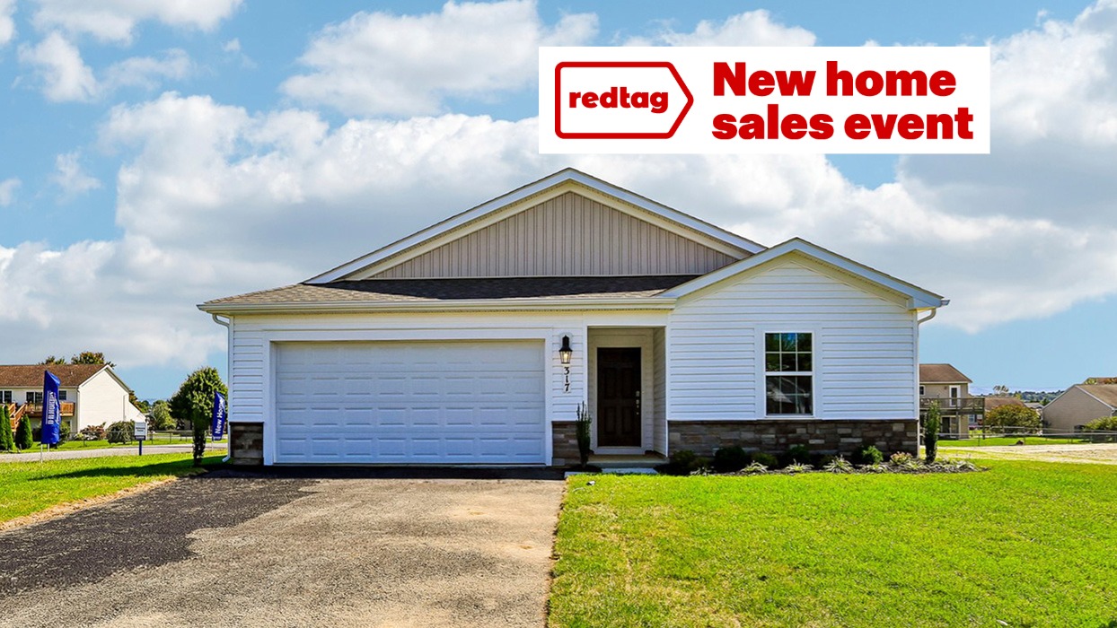 A Neuville exterior photo with white siding, champagne ledgestone kneewall, and a white garage door.