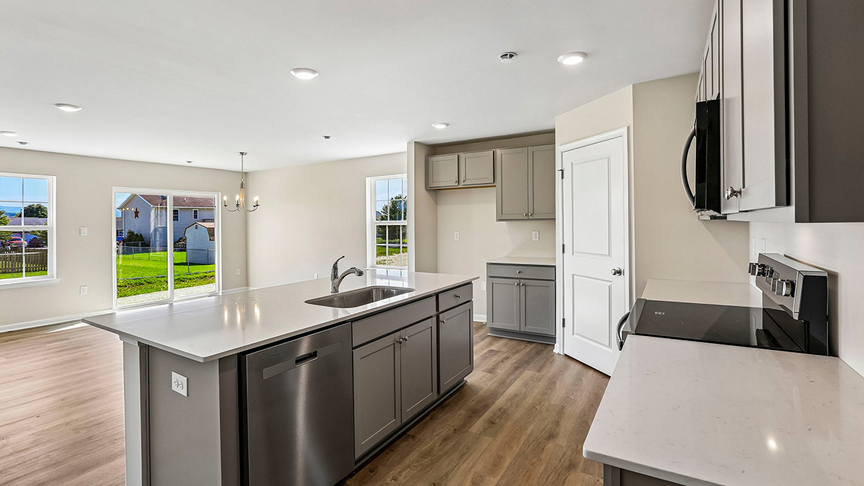 kitchen with gray cabinets and stainless steel appliances