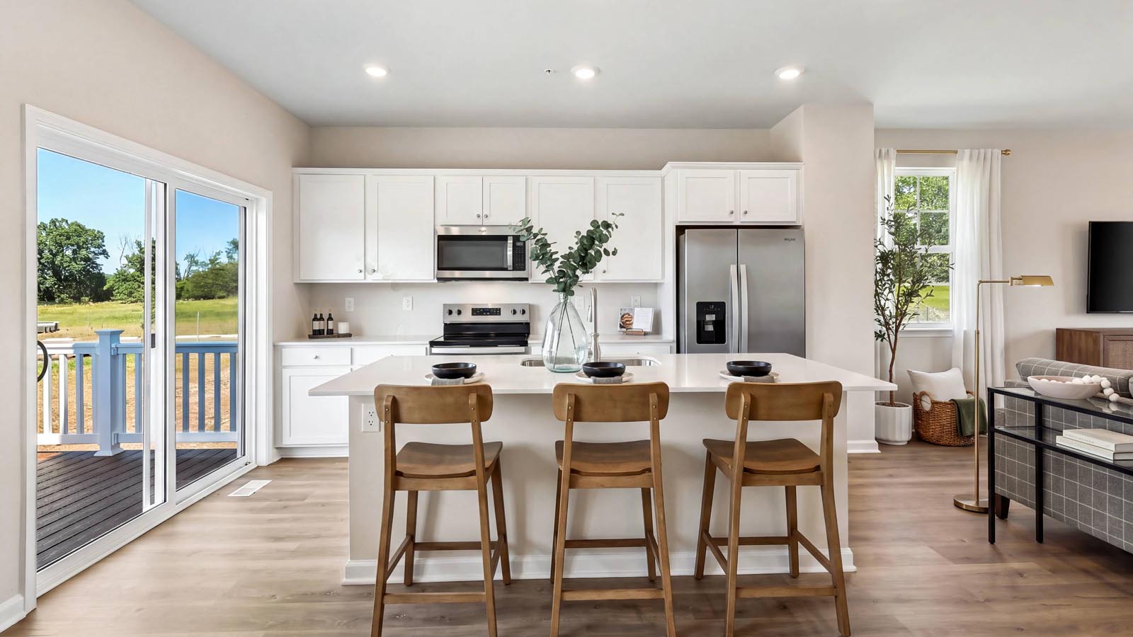 A view of the kitchen from the breakfast area with lots of natural light.