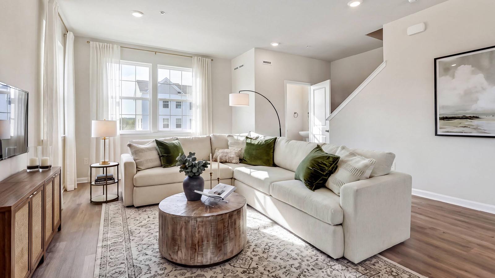 Open concept living with view towards the main living half bath.