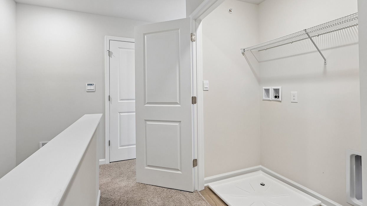 The laundry closet is located at the top stairs when you arrive on the third level.