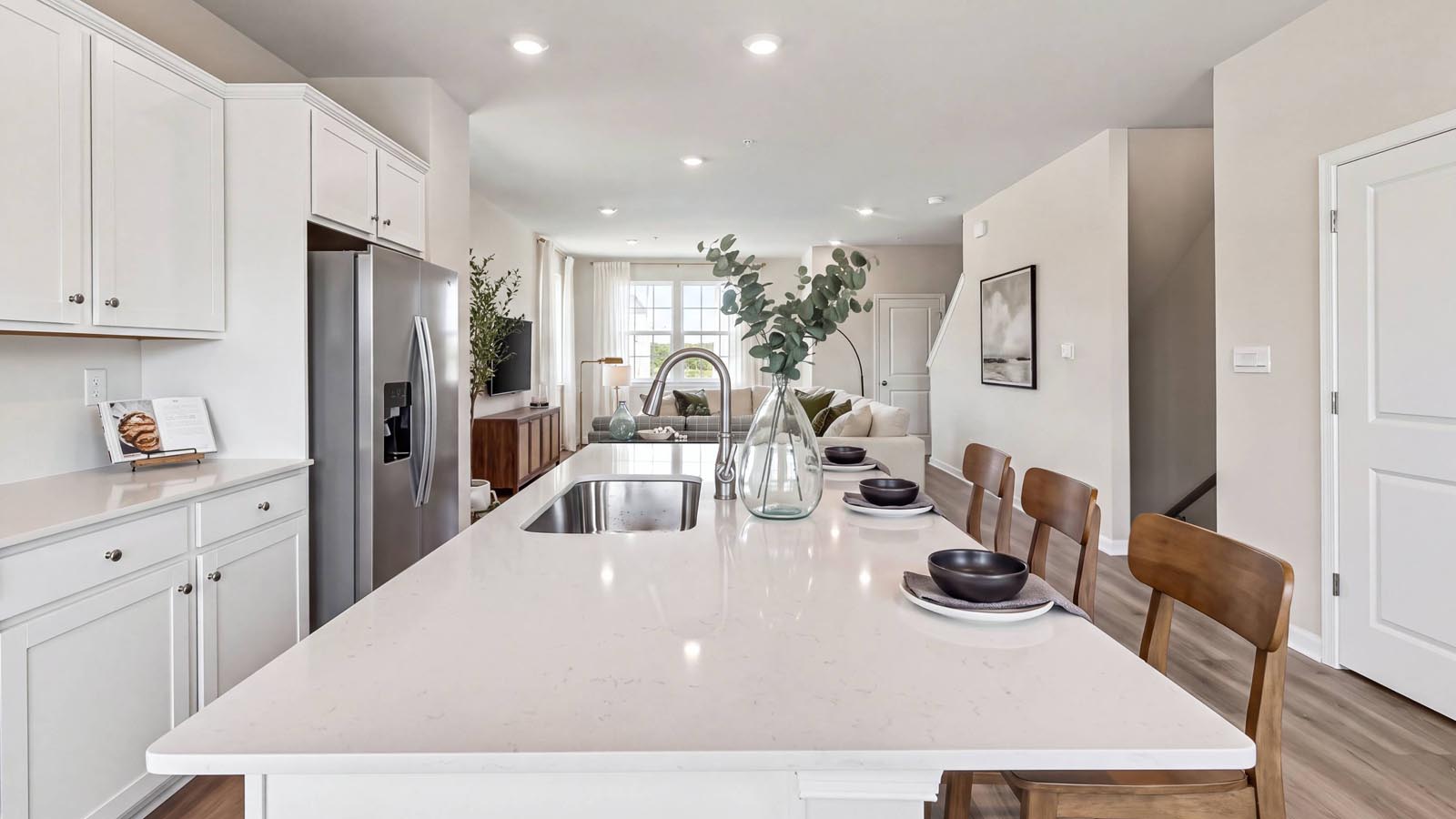 A large white kitchen island with a single bowl sink.