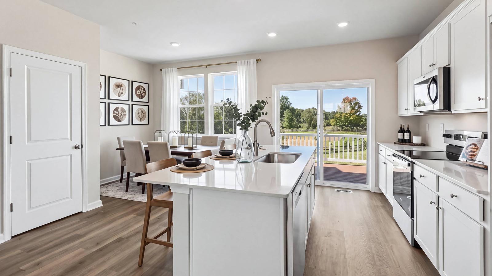 A view of the kitchen from living area with a view towards the deck.