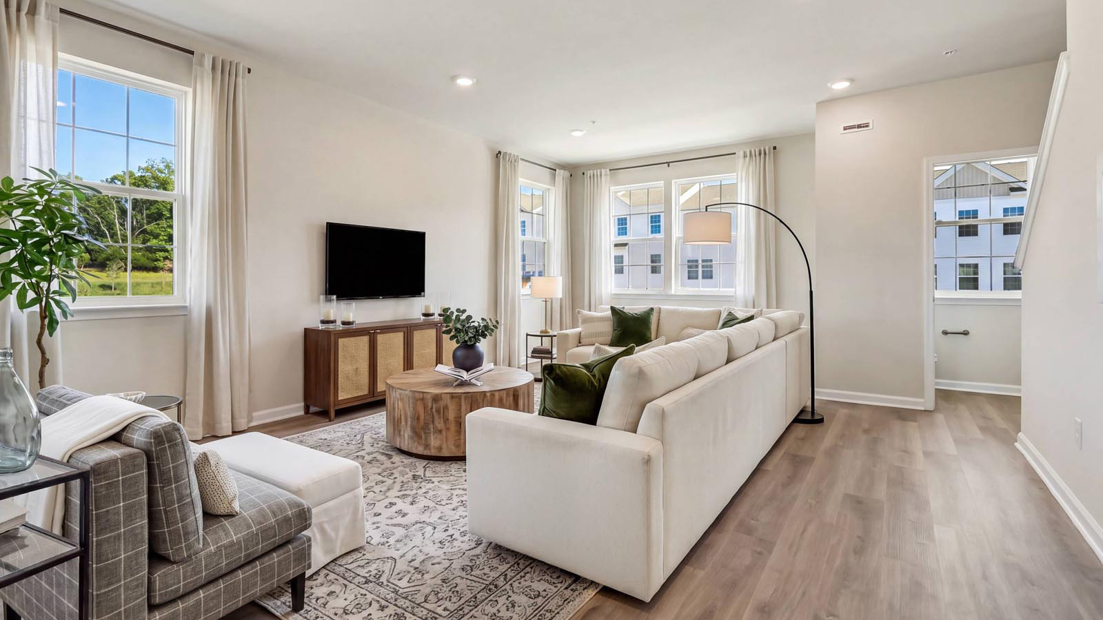 Open concept living with view towards the main living half bath.