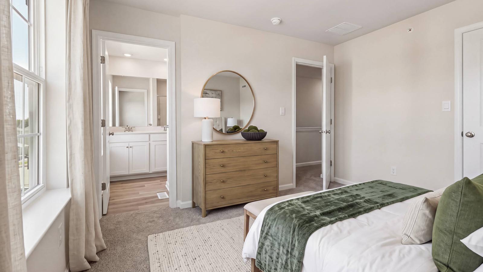Primary bedroom with privacy door to the en suite bathroom.