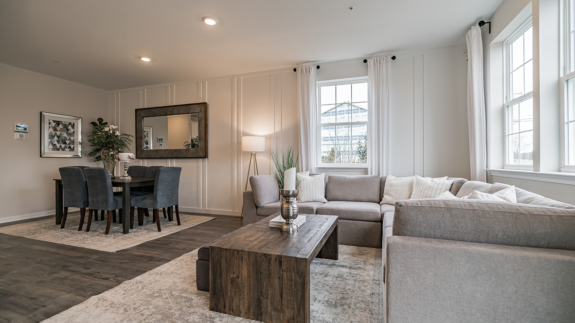 Living and dining area standing in front of the balcony door.