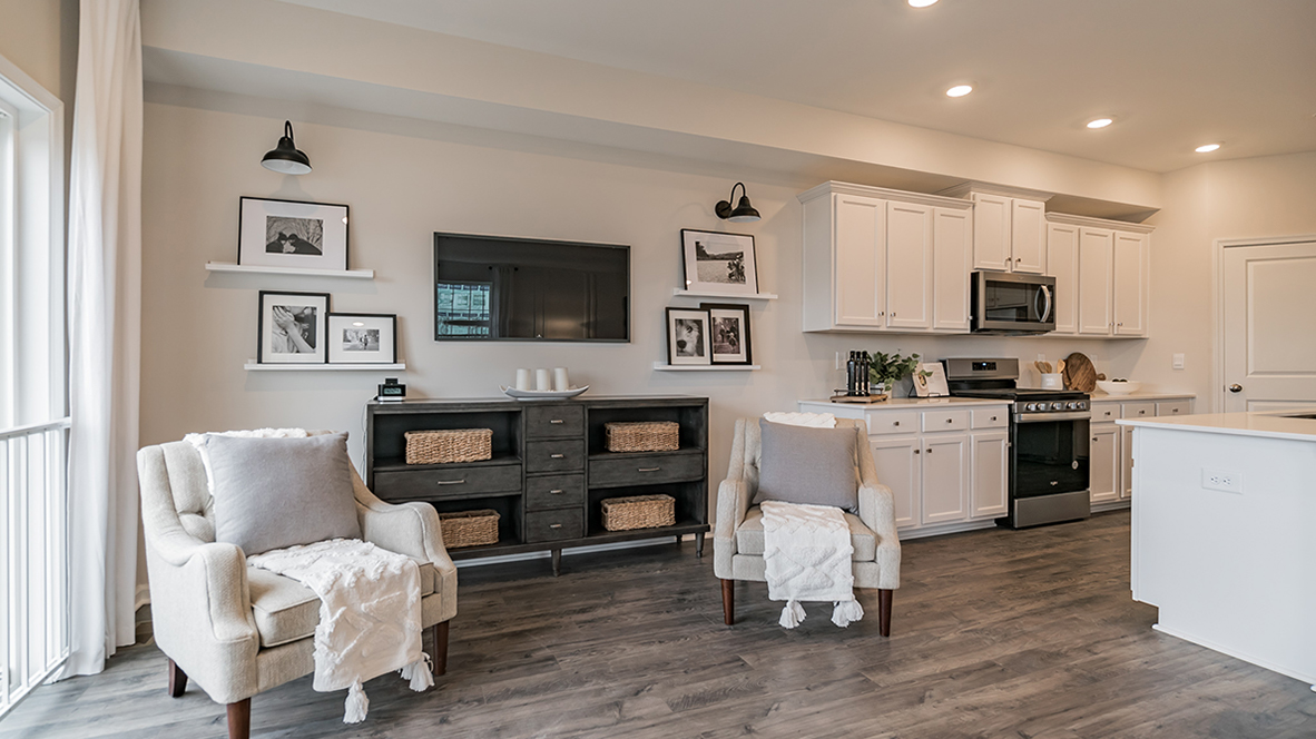 View in front of the couch in the living area with the kitchen to the right.