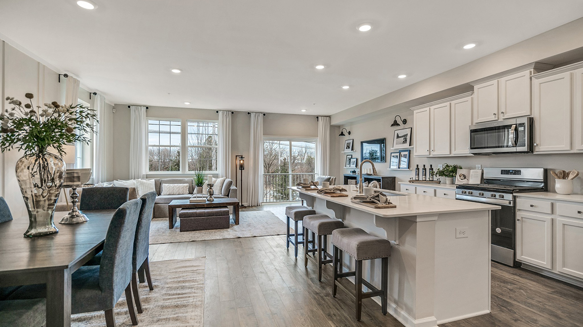 Open layout view of the kitchen, dining, and living area.