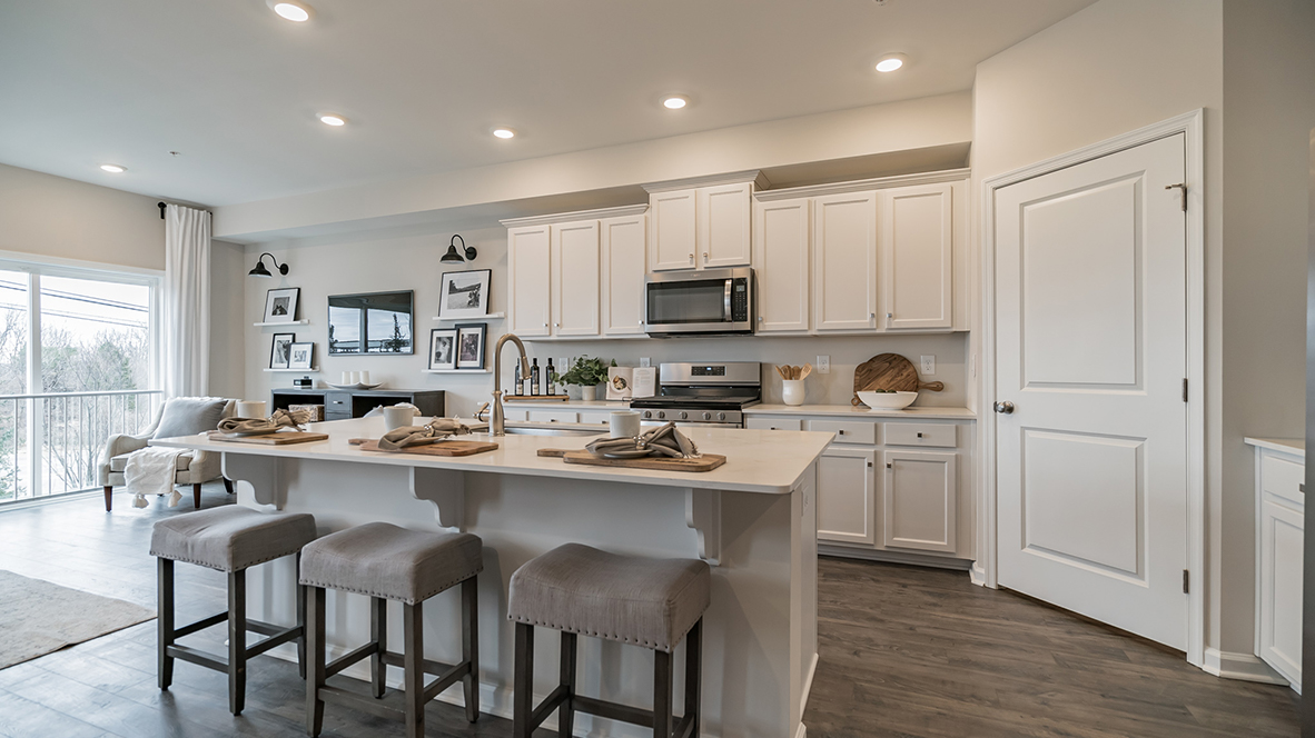 Open layout view of the kitchen island with the dining and living area.