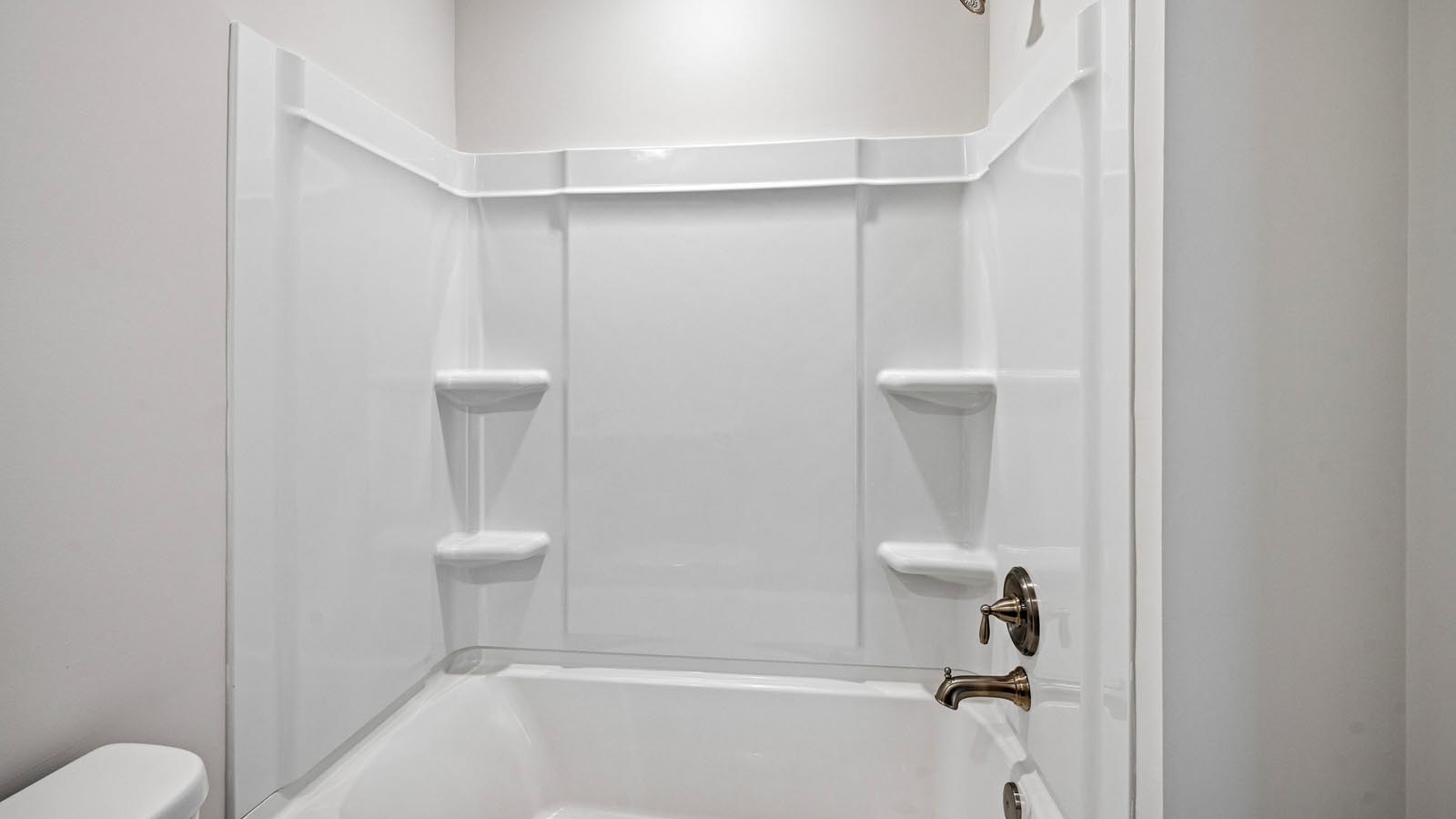 Secondary bath on the second floor with single sink vanity and shower tub.
