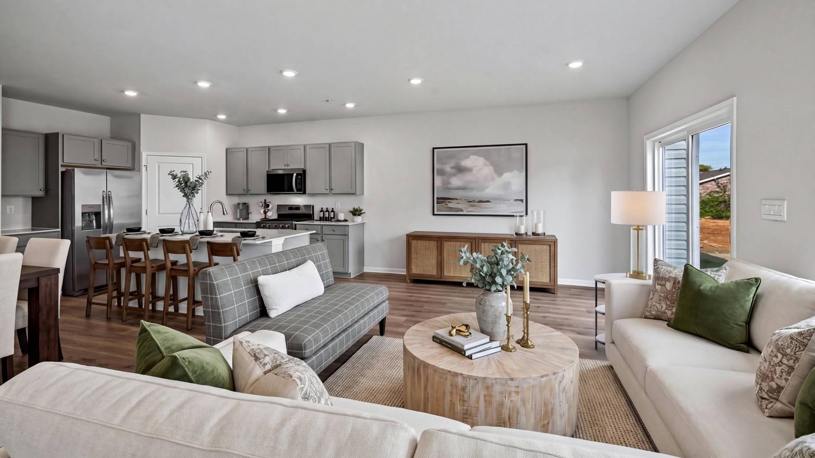 Open layout view of the kitchen island with the dining and living area.