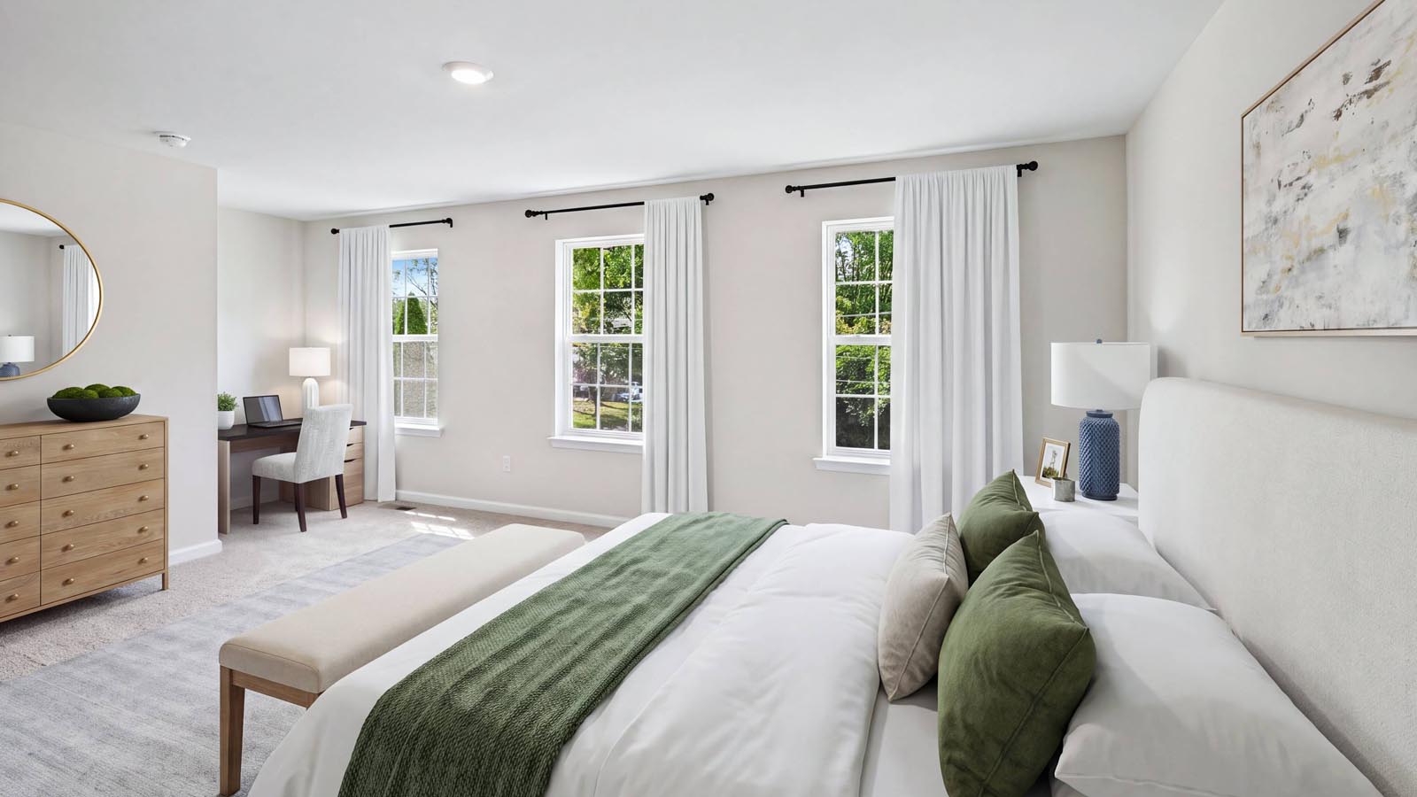 Primary bedroom on the second floor with three windows.