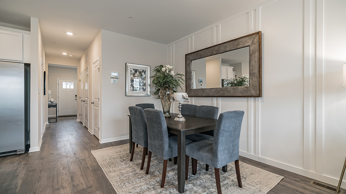 Dining area with view down the foyer hall with the half bath door to the right of the hall.