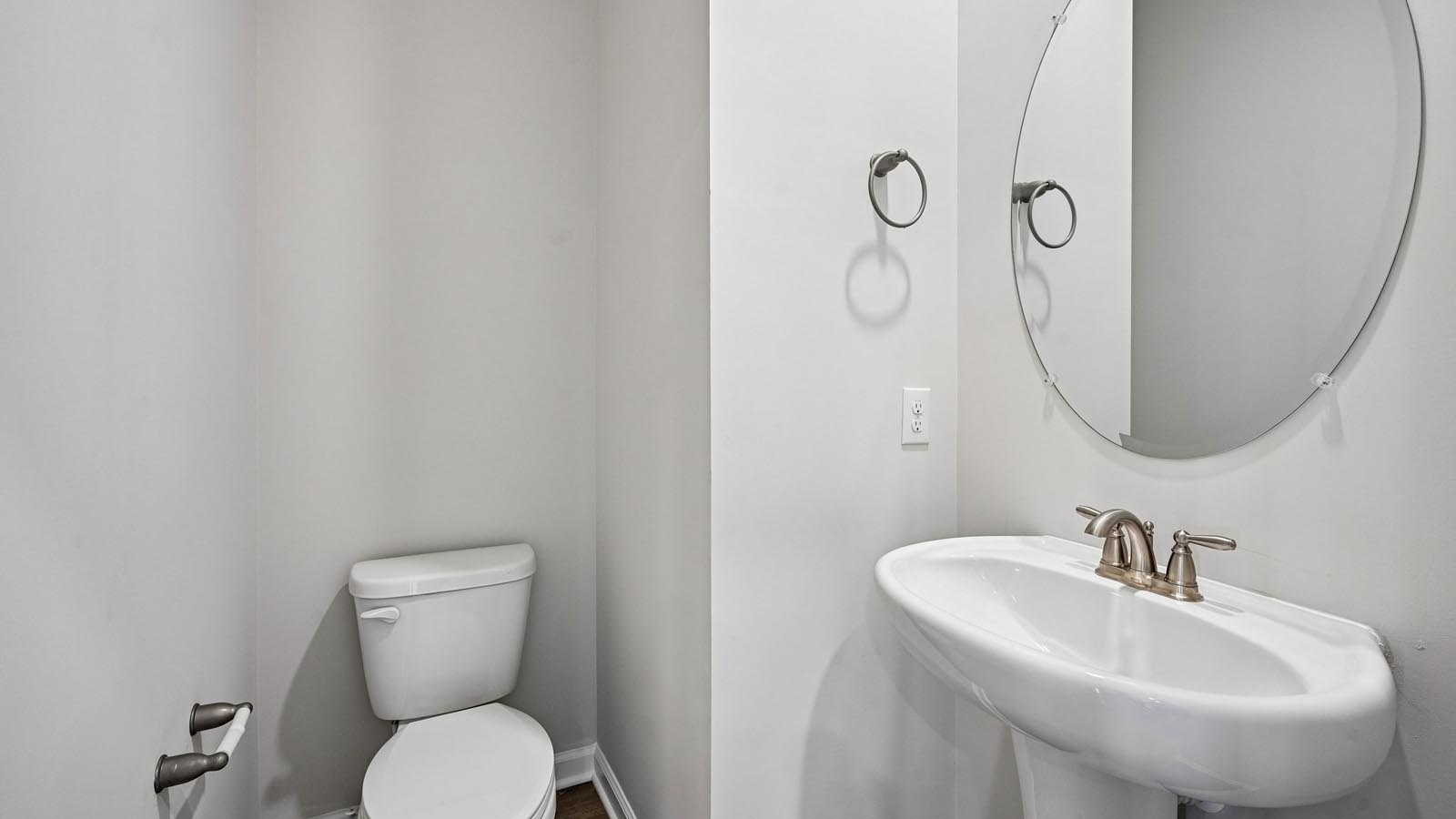 Half bath with a single bowl sink on the main living level.