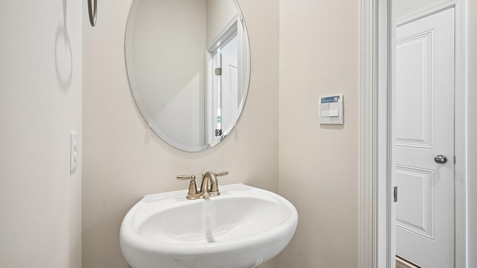 Half bath with a single bowl sink on the main living level.