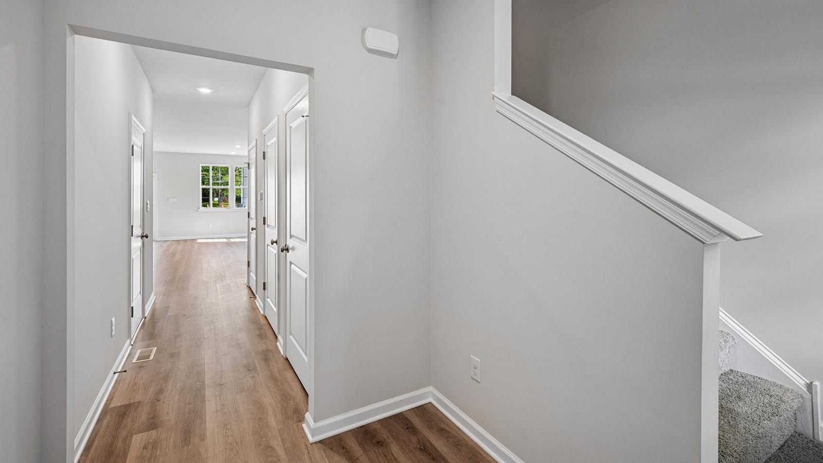 Foyer entrance facing toward the living area with stairs to the right.