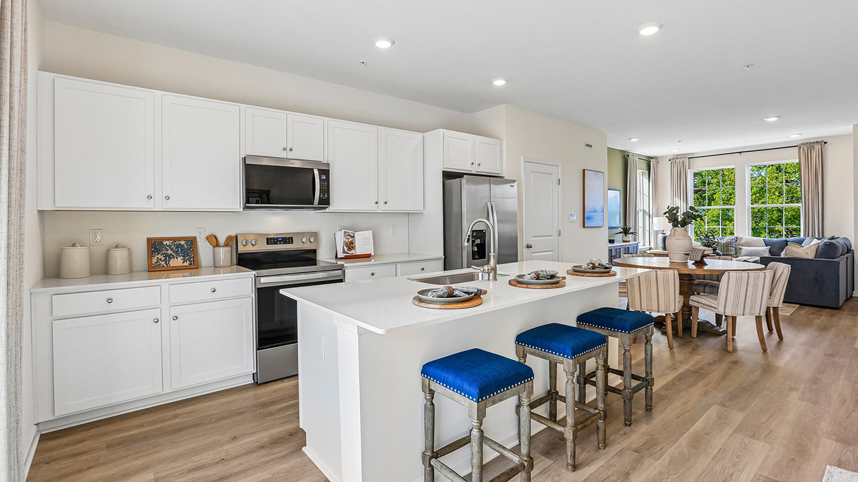 Bright kitchen that flows into the dining area and  living room space.