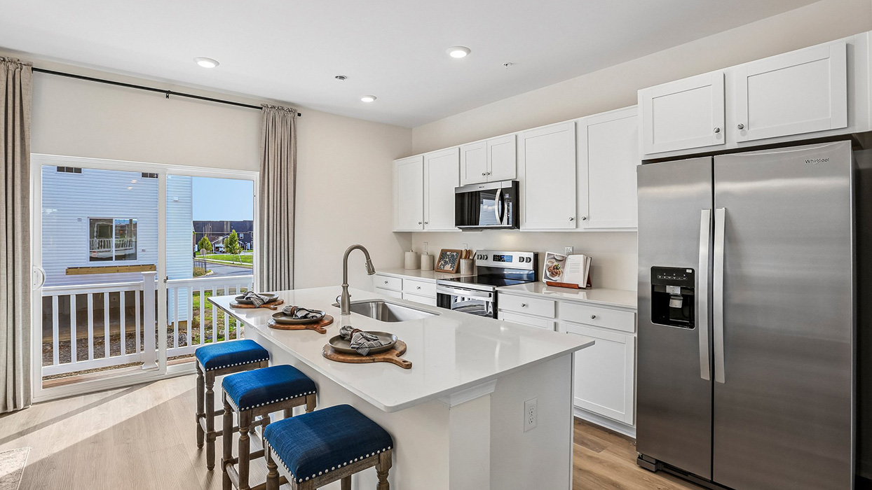 Kitchen area with sliding glass door and small deck on the back