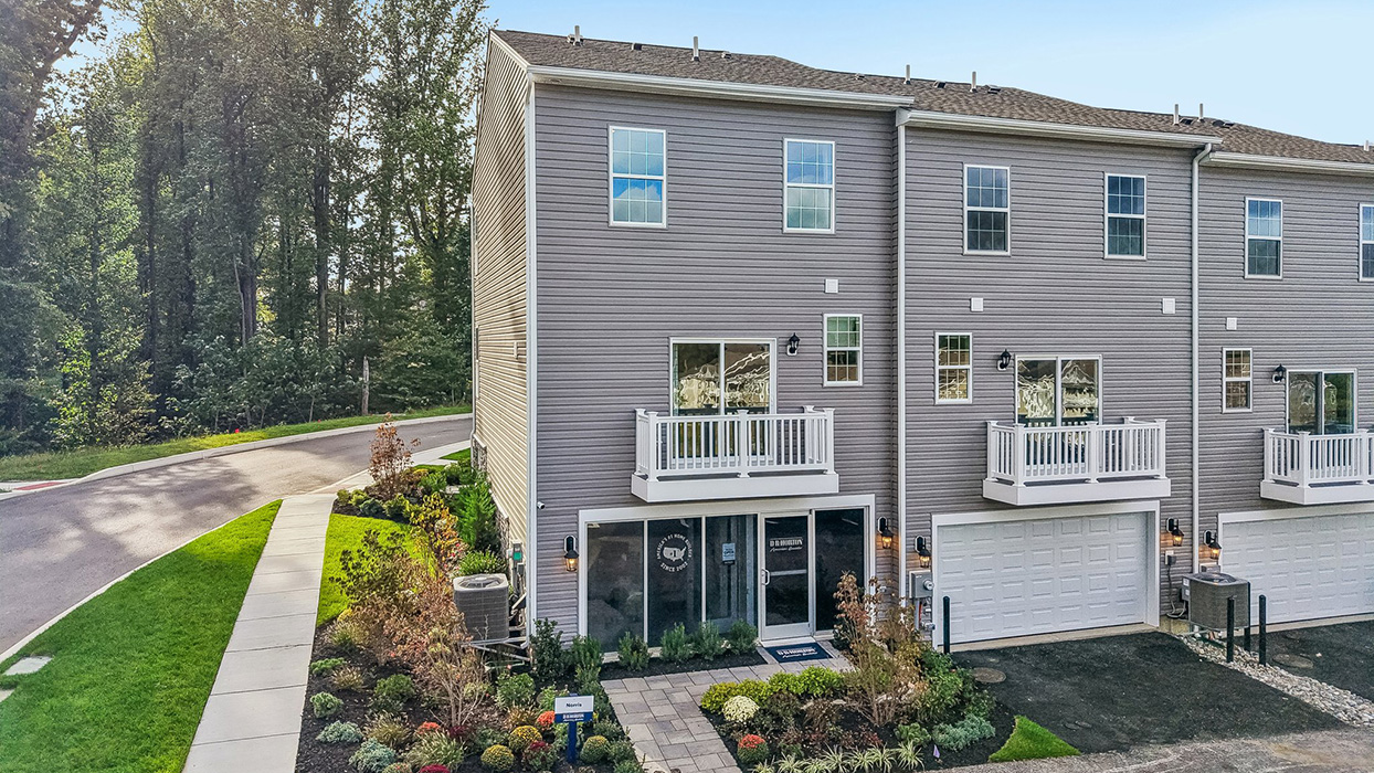 A rear view of a Norris 3 story townhome model unit with ground level sales center office