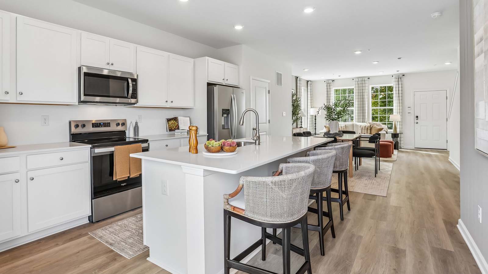 Bright kitchen that flows into the dining area and  living room space.