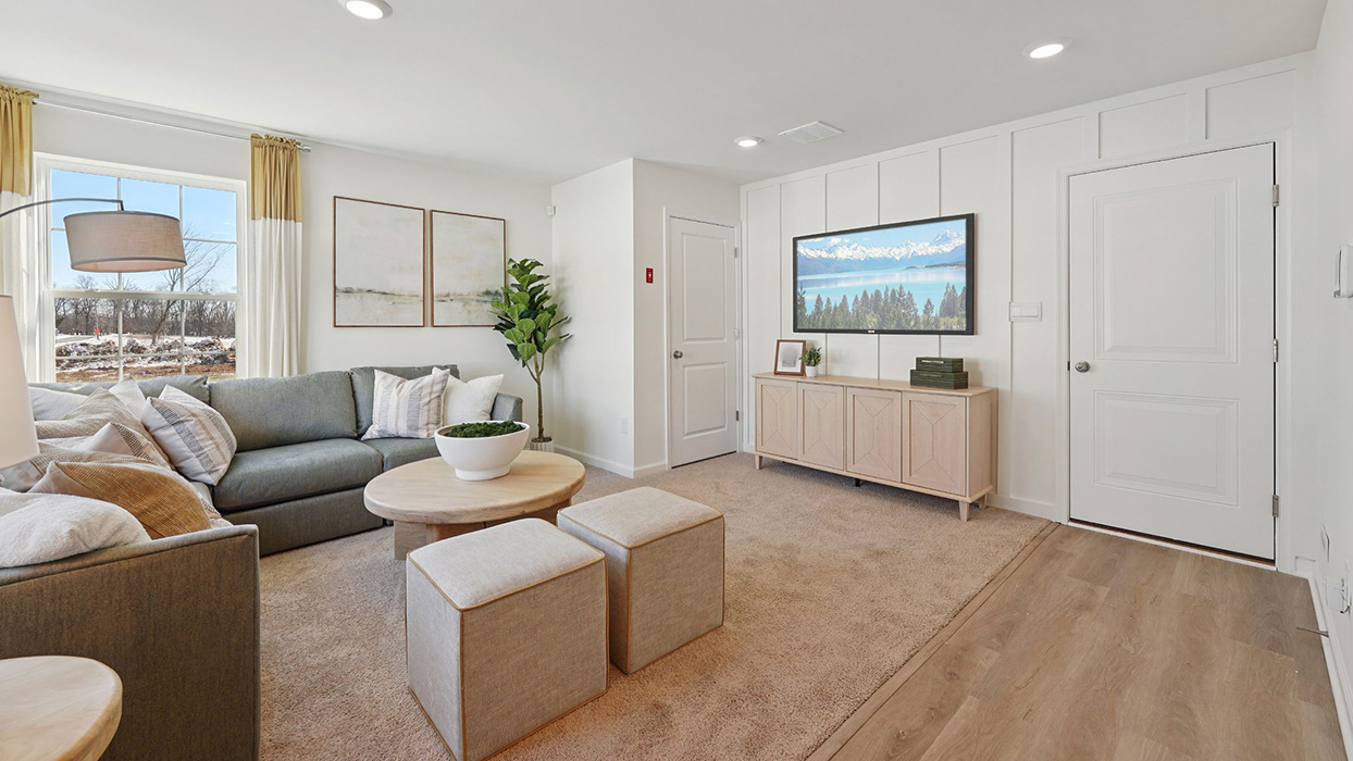 Recreation room with seating area, media console, and neutral finishes throughout